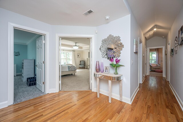 corridor with light wood-style floors and baseboards