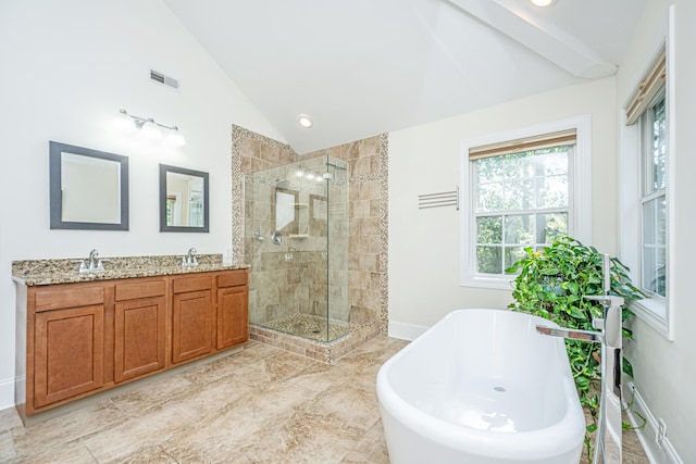 bathroom featuring vaulted ceiling, a shower stall, a soaking tub, double vanity, and recessed lighting