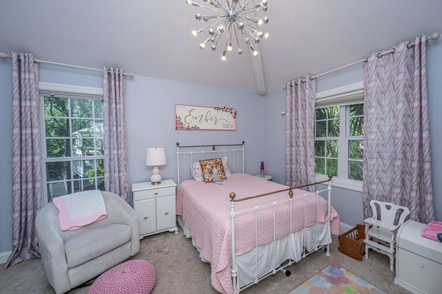 bedroom with carpet, multiple windows, vaulted ceiling, and a chandelier