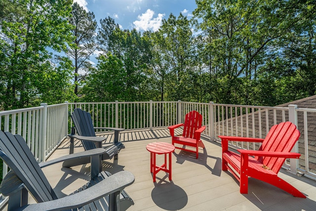 wooden deck featuring view of scattered trees