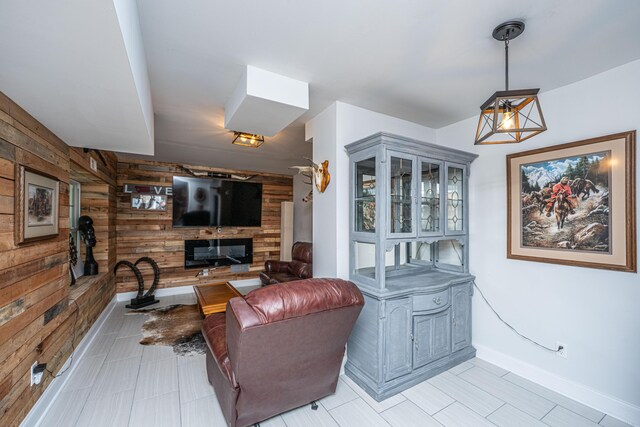 living room with wooden walls and baseboards