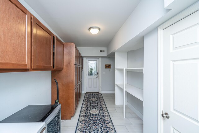 mudroom featuring baseboards and light tile patterned floors