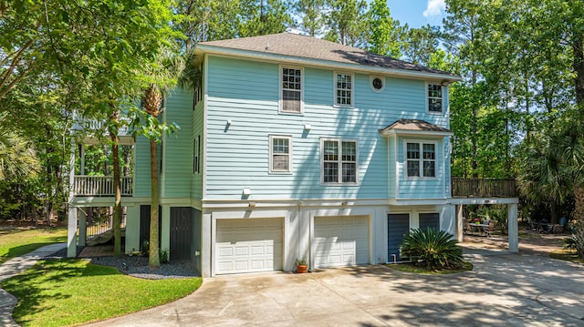 view of front of home featuring an attached garage, driveway, and stairs