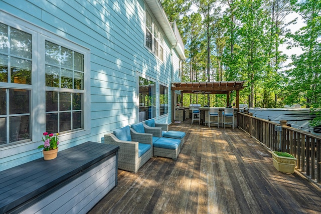 wooden terrace featuring a pergola and an outdoor living space