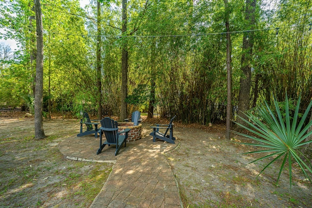 view of yard with an outdoor fire pit and a patio