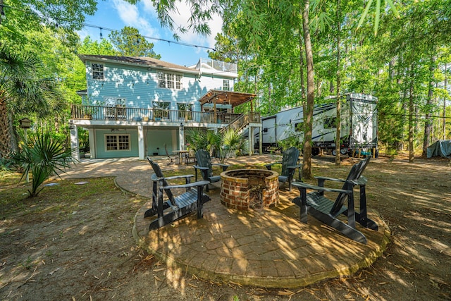 rear view of house featuring an outdoor fire pit, a patio area, and a deck