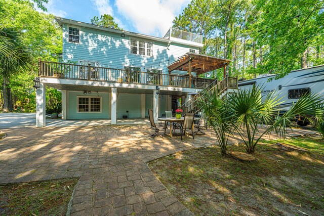 back of house with a patio area, a wooden deck, stairs, a pergola, and outdoor dining area