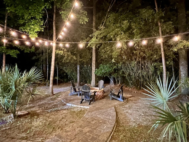 yard at night with a patio area
