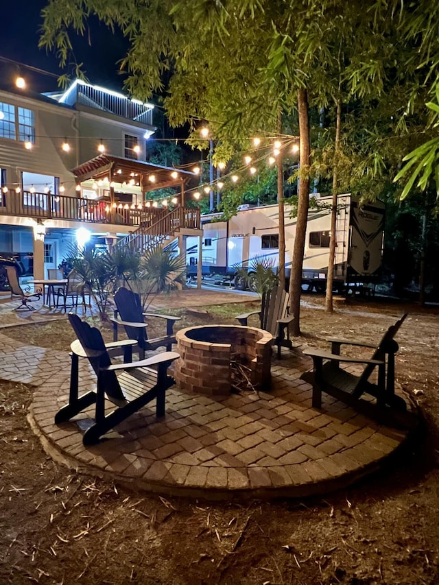 view of community with a fire pit and a patio area