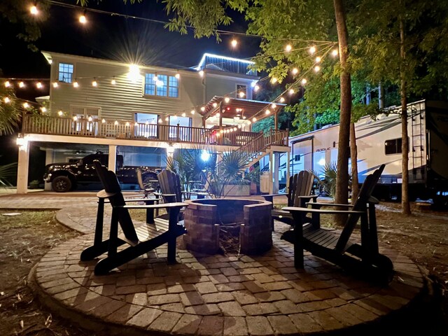 patio at twilight with stairs and a fire pit
