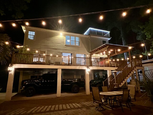 back of house at twilight featuring stairway