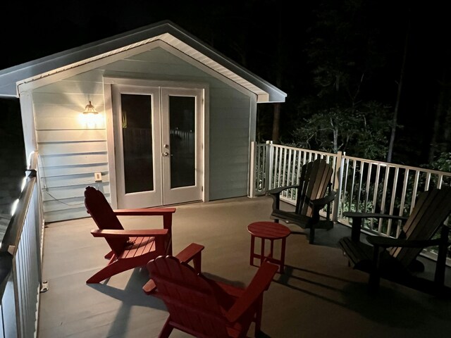 deck at night featuring french doors