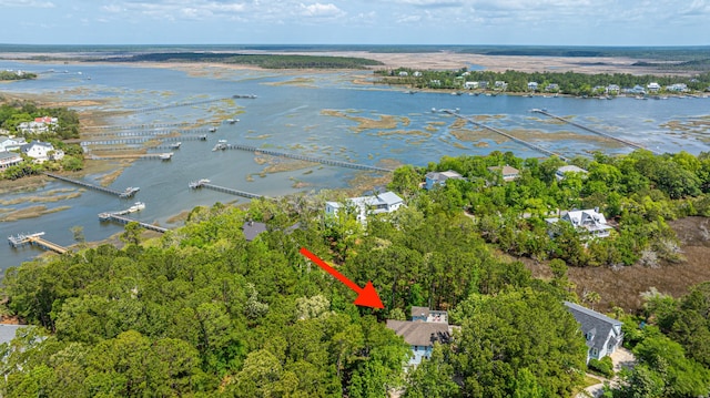 aerial view of property's location with a nearby body of water and numerous boat docks