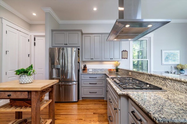 kitchen featuring island exhaust hood, appliances with stainless steel finishes, gray cabinets, and light wood-style flooring
