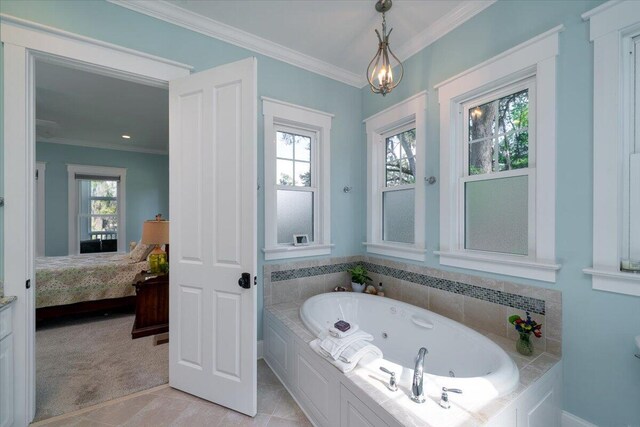 ensuite bathroom with ensuite bath, tile patterned floors, baseboards, a tub with jets, and ornamental molding