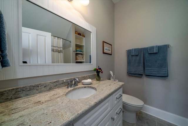 bathroom with a shower with curtain, vanity, baseboards, tile patterned floors, and toilet