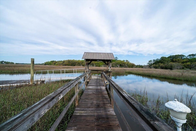 view of dock with a water view and a gazebo