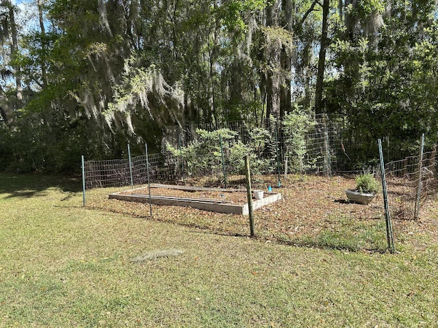 view of yard with a garden and fence