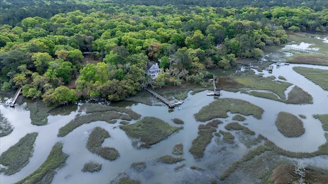 aerial view with a water view and a forest view