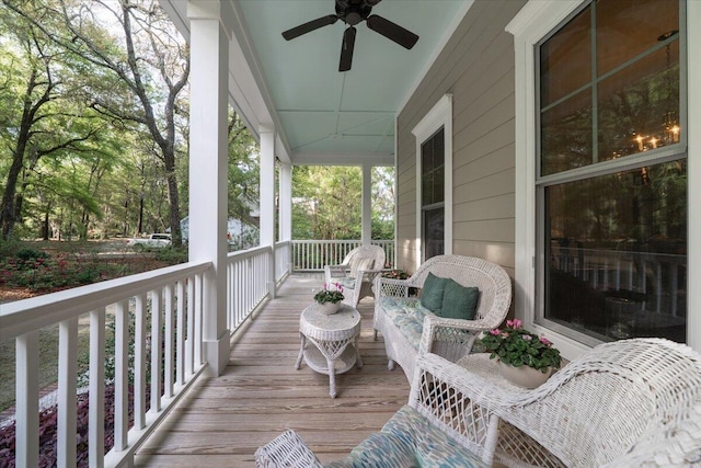 wooden terrace with ceiling fan and covered porch