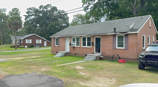 bungalow-style house with cooling unit and a front yard