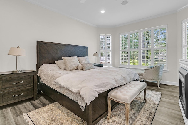 bedroom featuring crown molding, recessed lighting, baseboards, and light wood-type flooring