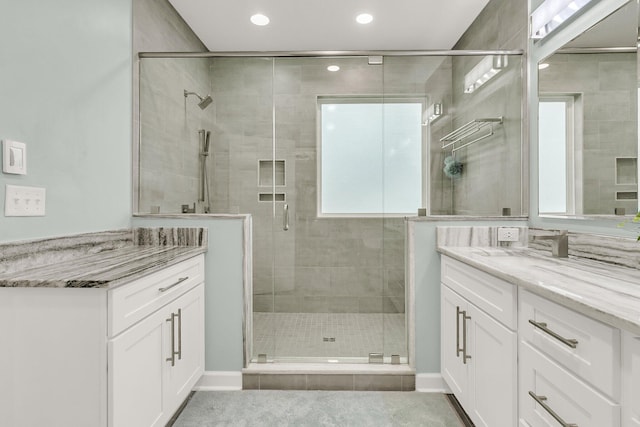 full bath with vanity, plenty of natural light, and a stall shower