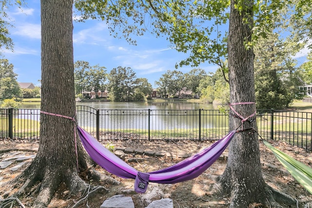 view of play area featuring fence and a water view