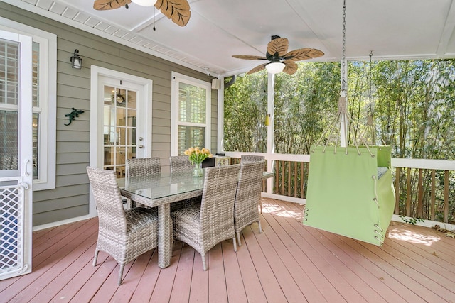 sunroom / solarium featuring a ceiling fan and outdoor dining space
