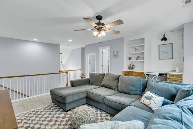 living area featuring visible vents, ceiling fan, recessed lighting, built in shelves, and carpet flooring
