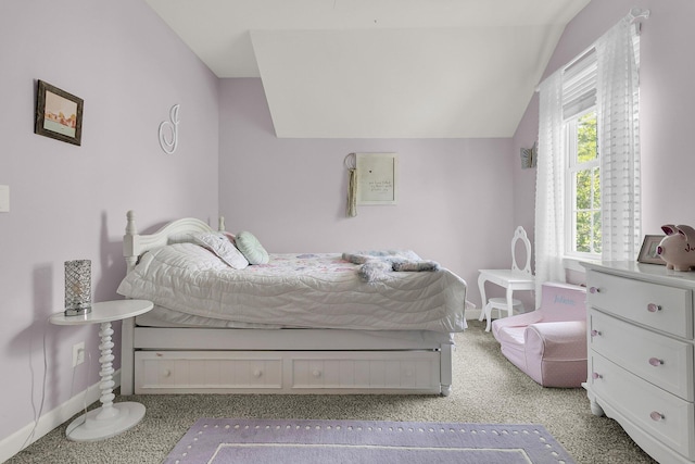 carpeted bedroom featuring baseboards and lofted ceiling