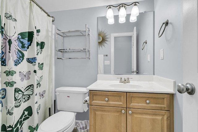 bathroom featuring toilet, curtained shower, and vanity
