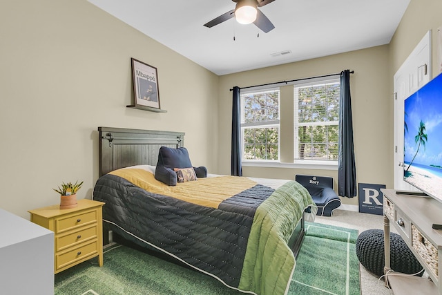 bedroom with carpet floors, ceiling fan, baseboards, and visible vents