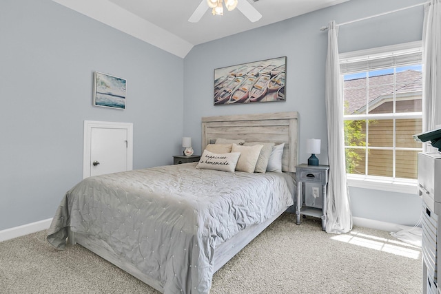 bedroom featuring carpet flooring, baseboards, vaulted ceiling, and ceiling fan