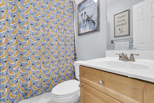 bathroom with vanity, toilet, and curtained shower