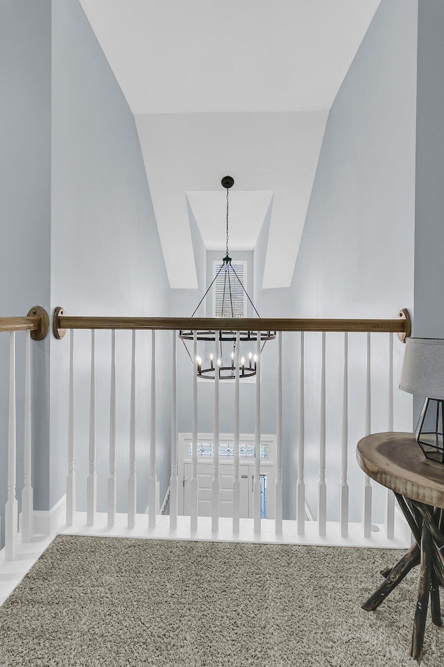 staircase featuring carpet flooring and an inviting chandelier