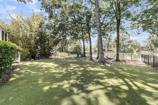 view of yard with fence and a water view