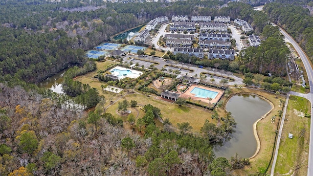 drone / aerial view featuring a view of trees and a water view