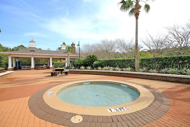 view of pool featuring a gazebo, a hot tub, and a patio area