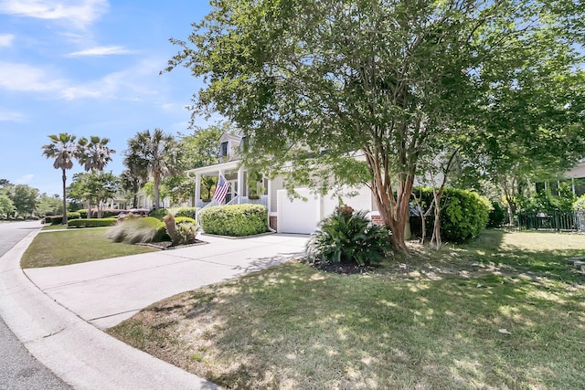 view of front of property featuring a garage, a front yard, and concrete driveway