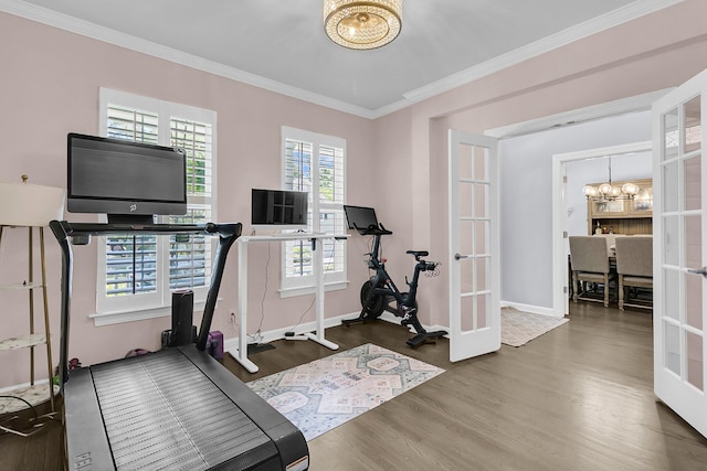 exercise room with a chandelier, french doors, baseboards, wood finished floors, and ornamental molding