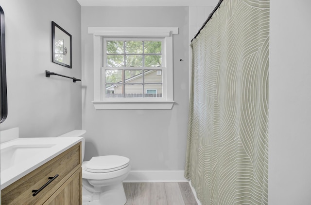 7674 Chippendale Rd, North Charleston, SC 29420 - full bathroom with vanity, toilet, wood finished floors, baseboards, and a shower with curtain