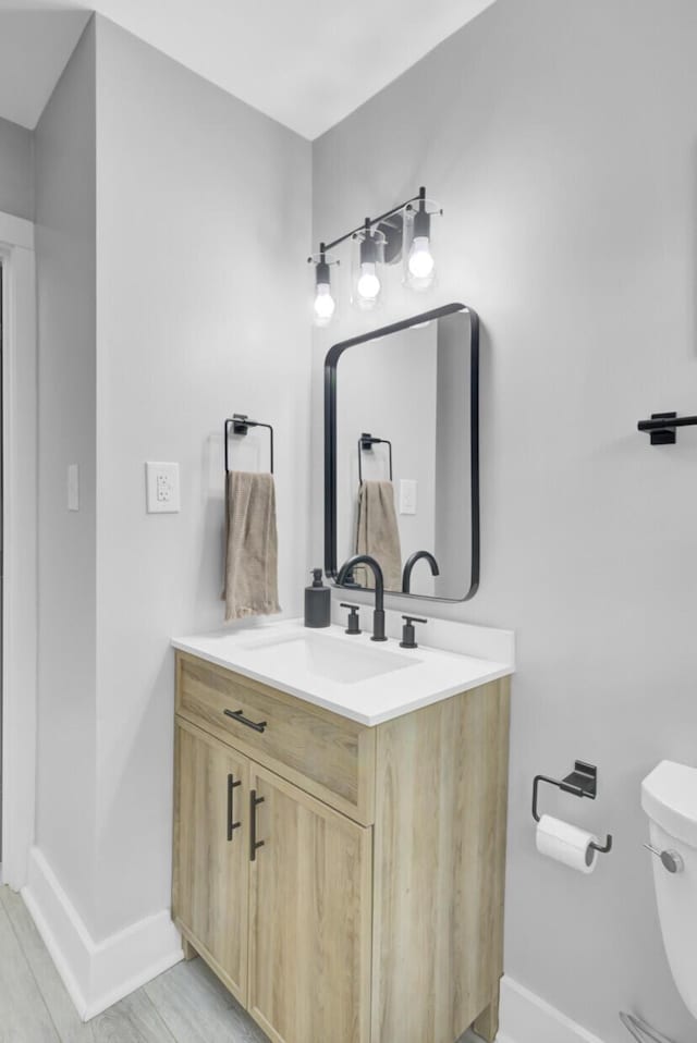 7674 Chippendale Rd, North Charleston, SC 29420 - bathroom featuring baseboards, vanity, and toilet
