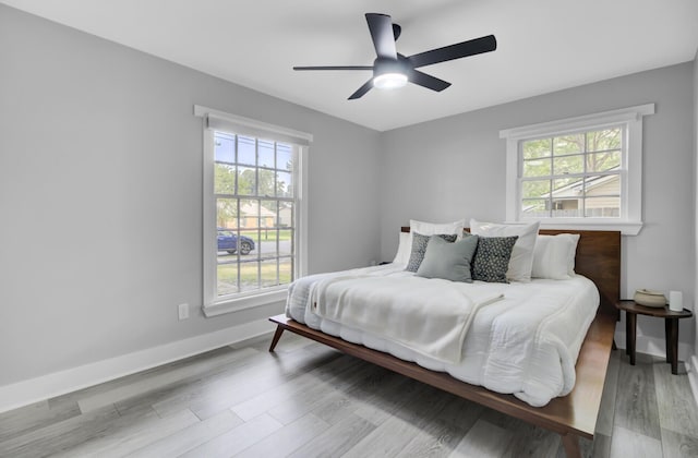7674 Chippendale Rd, North Charleston, SC 29420 - bedroom with multiple windows, wood finished floors, baseboards, and a ceiling fan