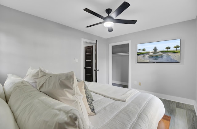7674 Chippendale Rd, North Charleston, SC 29420 - bedroom with baseboards, wood finished floors, a ceiling fan, and a closet