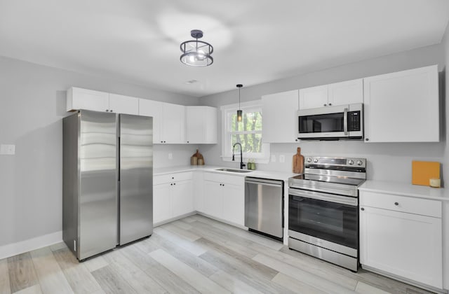 7674 Chippendale Rd, North Charleston, SC 29420 - kitchen featuring stainless steel appliances, a sink, light countertops, and white cabinetry