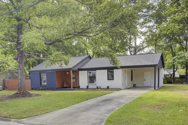 7674 Chippendale Rd, North Charleston, SC 29420 - view of front facade with driveway, brick siding, a shingled roof, a front yard, and an attached carport