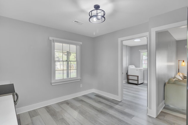 7674 Chippendale Rd, North Charleston, SC 29420 - unfurnished room with washer / clothes dryer, light wood-style flooring, and baseboards