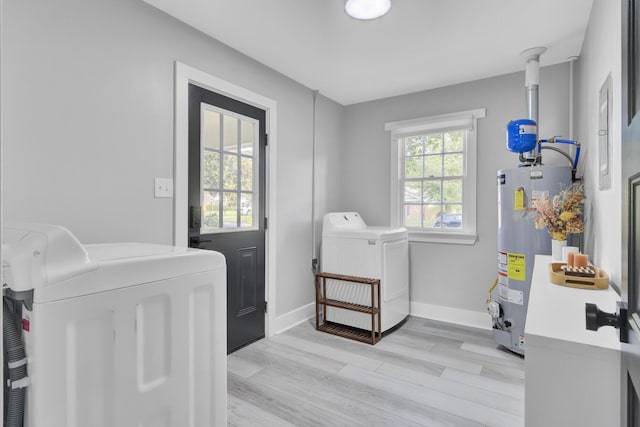 7674 Chippendale Rd, North Charleston, SC 29420 - laundry area with washer and dryer, gas water heater, light wood-type flooring, and baseboards