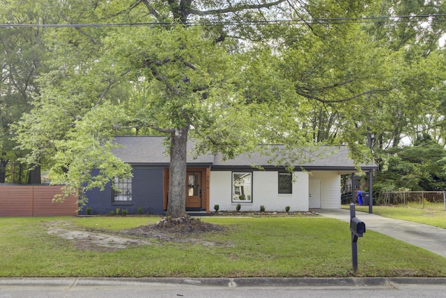 7674 Chippendale Rd, North Charleston, SC 29420 - view of front of home featuring driveway, a shingled roof, brick siding, and a carport